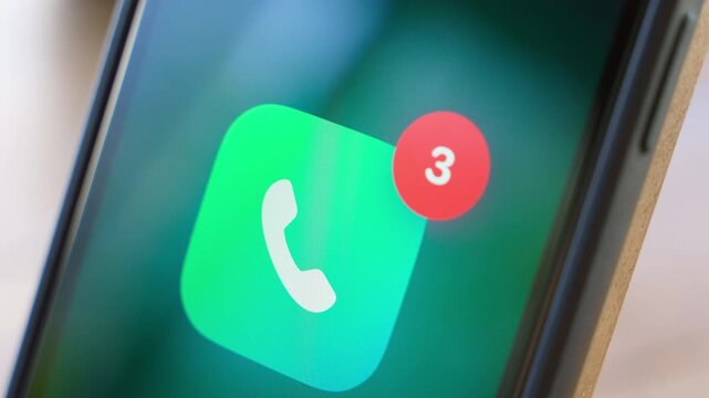 Missed calls notification badge on phone app icon on smartphone screen close-up
