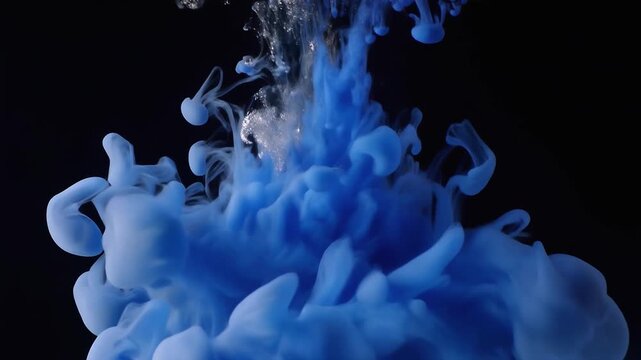 Blue Ink Cloud in Water: A dramatic, ethereal cloud of blue ink disperses in dark water, creating mesmerizing swirls and patterns that evoke a sense of mystery and fluidity.
