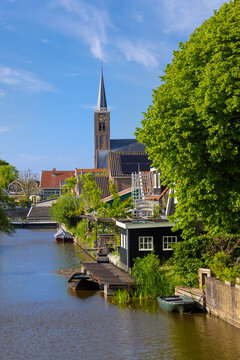 Schermerhorn village canal with Church of Schermerhorn and traditional houses in Netherlands.