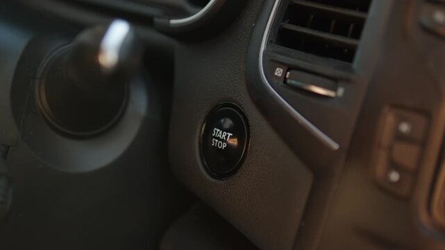 Close Up of Hand Pressing Start Stop Engine Button in Modern Car Interior, Person Starting Vehicle Ignition with Push Button Footage, Car Technology and Automotive Feature Concept, Driving Preparation