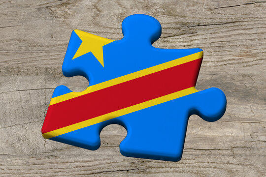 3D illustration. Flag of DR Congo on a jigsaw puzzle pieces on a wood background.