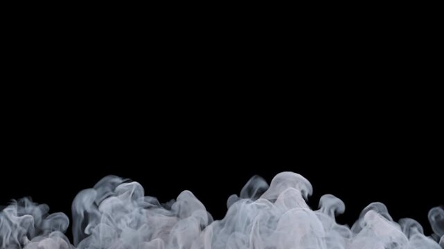 Thick white smoke rising slowly on black background.