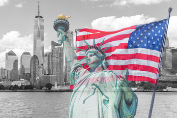 Statue of Liberty with a large american flag and New York skyline in the background © Maria