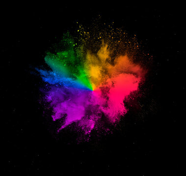 Colorful dust explosion of holi paint powder explosion isolated on black background