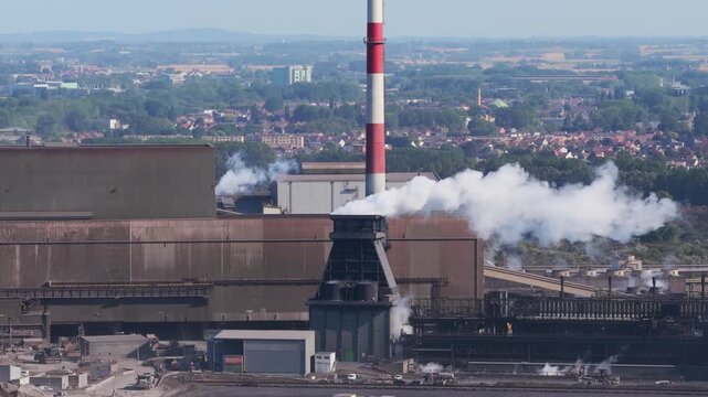 Aerial drone view of a heavy metallurgical plant producing steel. Industrial facility with manufacturing buildings and infrastructure.