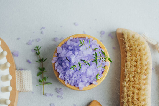 lavender bath salt and spa brushes on gray background