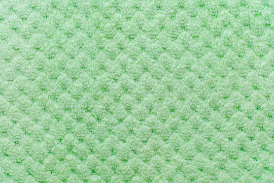 Soft textured fabric surface with light green hue