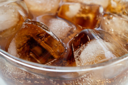 Macro Close Up of cola bubbles and ice cubes background