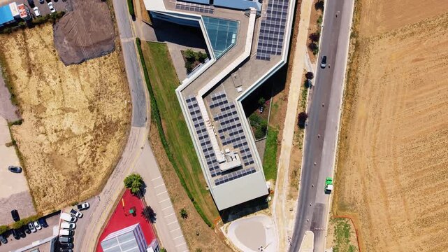 Aerial view of the roundabout and commercial buildings with solar panels at Rte de Crassier 11 in Eysins, Vaud, Switzerland.