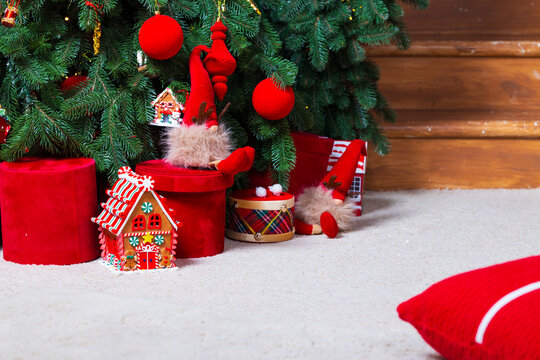 decorated Christmas tree with presents and festive ornaments creates a cozy holiday scene on a quiet morning