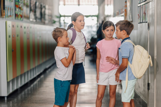 School children talking in a corridor with lockers