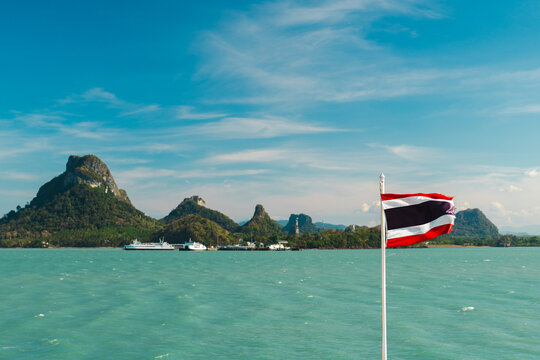 Thai Flag Flying Over Turquoise Sea and Mountainous Islands