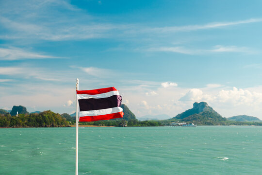 Thai Flag Flying over Turquoise Sea and Karst Mountains