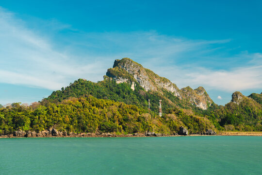 Forested Limestone Mountain Coastline Viewed Across Turquoise Water