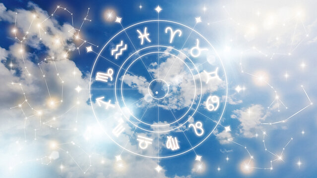 Astrology zodiac signs displayed against a bright sky with clouds and light