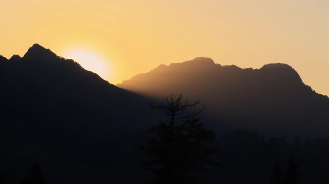 4K Silhouette shot of Himalayan mountain range during the sunset as seen from Kais Dhar near Kullu in Himachal Pradesh, India. Scenic view of sunset in the Himalayas. Natural background.