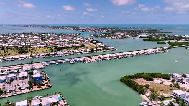 Aerial view of florida keys waterfront neighborhood with boat docks and turquoise ocean water.