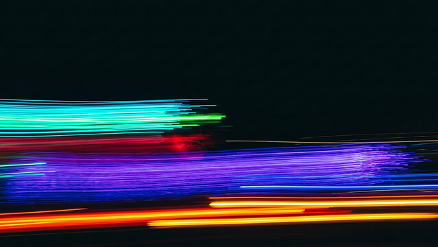 Neon Kinetic Energy in Motion A Vibrant Long-Exposure Abstract of Colorful Horizontal Light Trails Against a Pitch-Black Night Sky