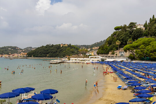 Sunny summer day at a popular Italian seaside destination with people swimming and relaxing