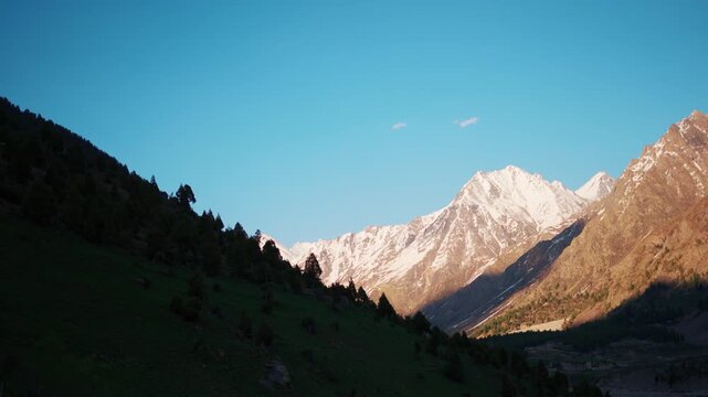 4K Landscape shot of Himalayan mountain peak with snow on top during the sunset as seen from Miyar Valley in Lahaul and Spiti district, Himachal Pradesh, India. Scenic natural background. 