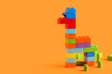 Naklejka premium Animal figure made of colorful plastic building blocks on orange background