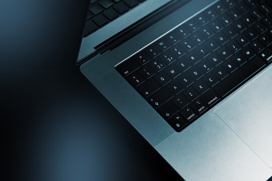 Close-up view of a laptop on a dark surface during a late evening setup for work or study