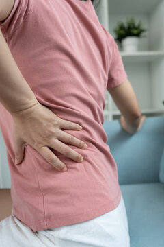 woman holding lower back while and suffer from unbearable pain health and problems, chronic back pain, backache in office syndrome, scoliosis, herniated disc, muscle inflammation