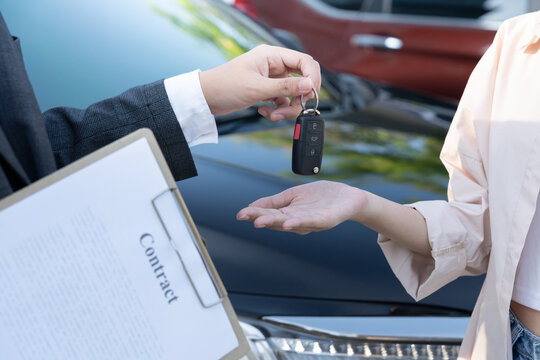 lease, rental car, sell, buy. Dealership manager send car keys to the new owner. Sales, loan credit financial, rent vehicle, insurance,  renting, Seller, dealer, installment, car care business