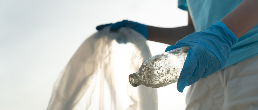 Save water. Volunteer pick up trash garbage at the beach and plastic bottles are difficult decompose prevent harm aquatic life. Earth, Environment, Greening planet, reduce global warming, Save world
