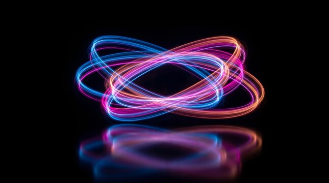 Abstract swirling light trails in vibrant pink and blue against a dark background