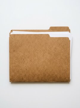 Brown Manila File Folder with White Documents Isolated on White Background for Office Organization and Business Documentation