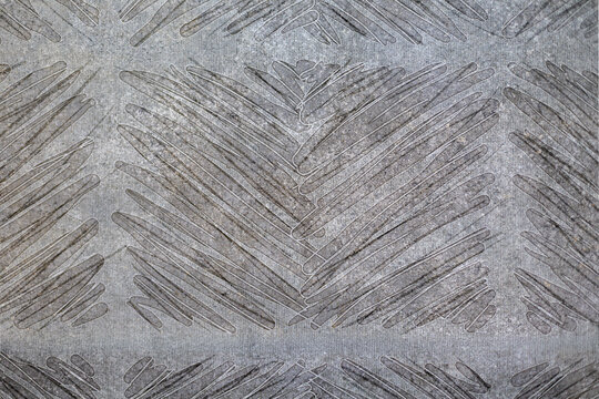 Gray Geometric Chevron Pattern Texture. Gray textured geometric surface with layered diagonal lines forming repeating chevron patterns and weathered details.