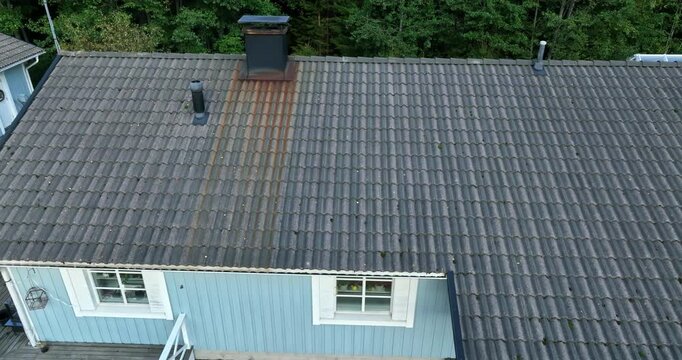 Aerial view of a house roof rust spreading from the chimney on dirty roof tiles