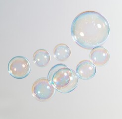 Obraz premium Colorful iridescent soap bubbles floating against white background