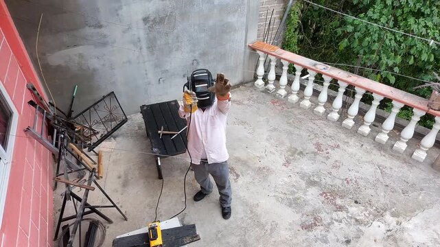 Welder Waving Hand Friendly to Drone Camera Before Starting Work