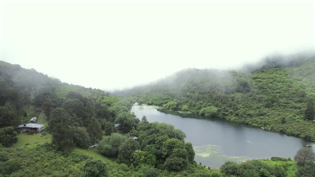 4K drone aerial view of Yala Provincial Park in Jujuy, Argentina. Misty mountain lakes surrounded by lush Yungas forests and dense green vegetation in a spectacular Andean landscape.