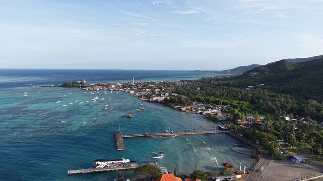 Aerial view of Karimunjawa Harbor in Indonesia featuring turquoise waters, tropical islands, scenic coastline and a beautiful maritime landscape from above.