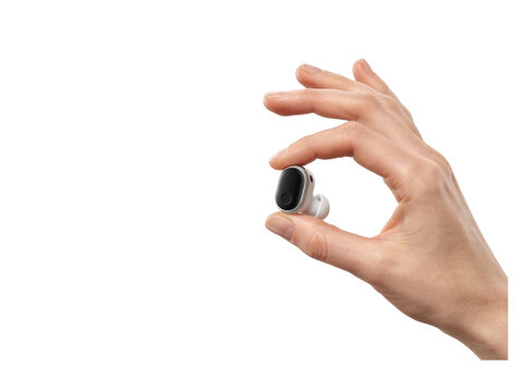 Hand holding small wireless earbud in open palm against clear background transparent background