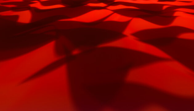Red fabric with flowing folds and shadow patterns close-up