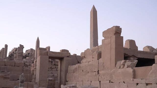 Ancient karnak temple ruins with towering egyptian stone obelisks in luxor.