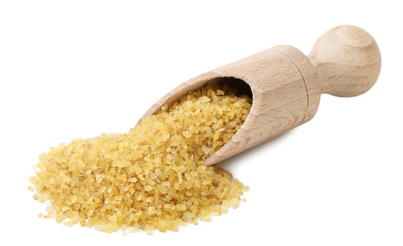 Bulgur grains spilling from a wooden spatula on a white. Isolated