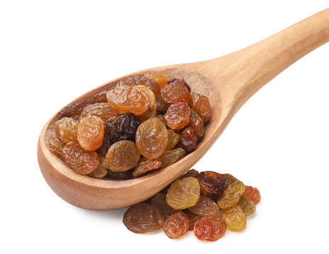 Raisins in a wooden spoon on a white background. Isolated