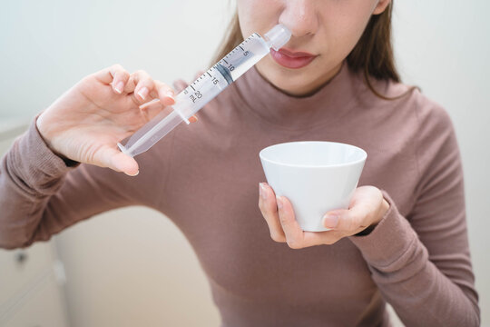 Close-up shot of woman cleaning her nasal.