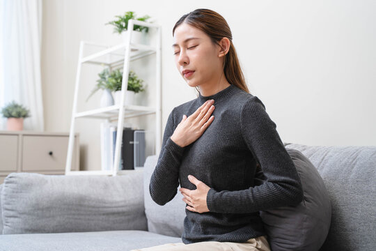 Women feeling pain in her chest from reflux acid