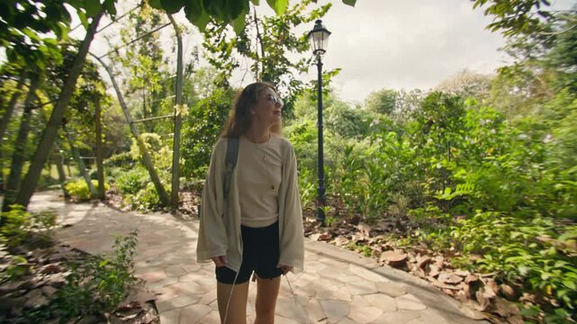 Female traveler exploring Singapore Botanic Gardens with tropical vegetation lush landscapes and peaceful nature in the heart of a modern Asian metropolis