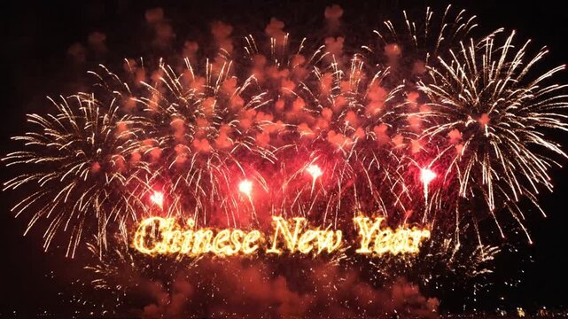 Golden fireworks display with Chinese New Year text in night