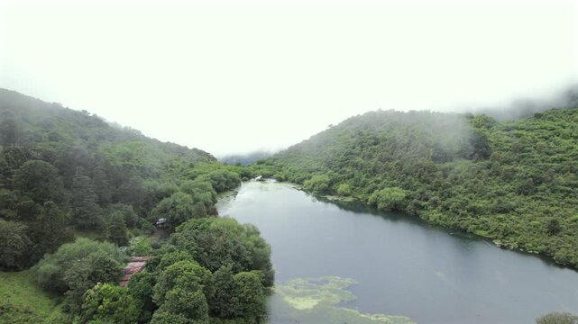 4K drone aerial view of Yala Provincial Park in Jujuy, Argentina. Misty mountain lakes surrounded by lush Yungas forests and dense green vegetation in a spectacular Andean landscape.