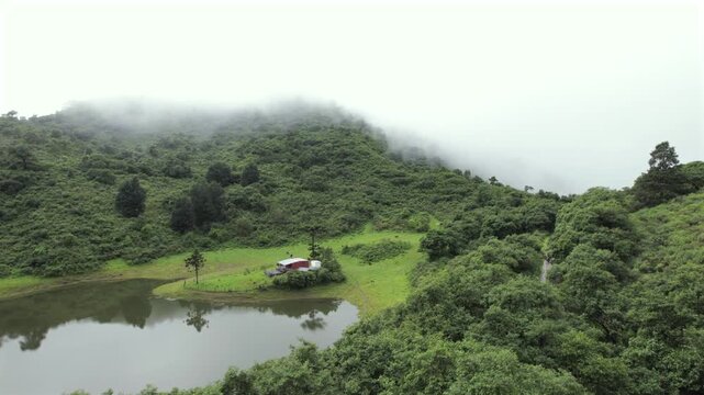 4K drone aerial view of Yala Provincial Park in Jujuy, Argentina. Misty mountain lakes surrounded by lush Yungas forests and dense green vegetation in a spectacular Andean landscape.