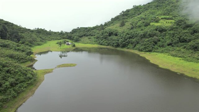4K drone aerial view of Yala Provincial Park in Jujuy, Argentina. Misty mountain lakes surrounded by lush Yungas forests and dense green vegetation in a spectacular Andean landscape.