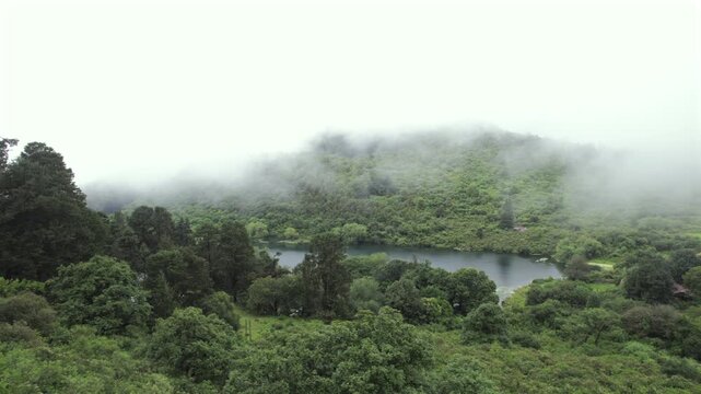 4K drone aerial view of Yala Provincial Park in Jujuy, Argentina. Misty mountain lakes surrounded by lush Yungas forests and dense green vegetation in a spectacular Andean landscape.